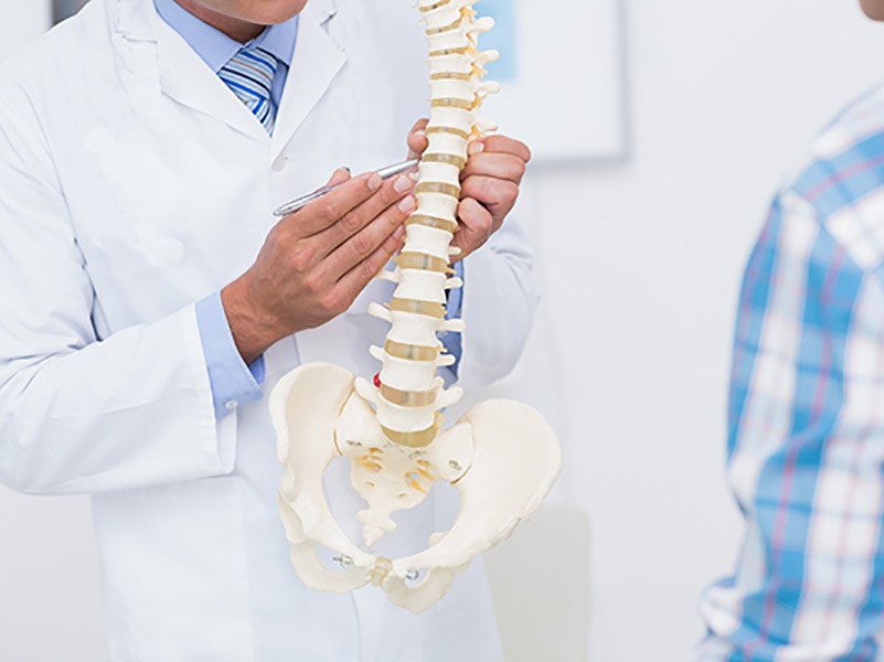 dr. neil cochrane educating a patient about their spine condition as part of his treatment philosophy